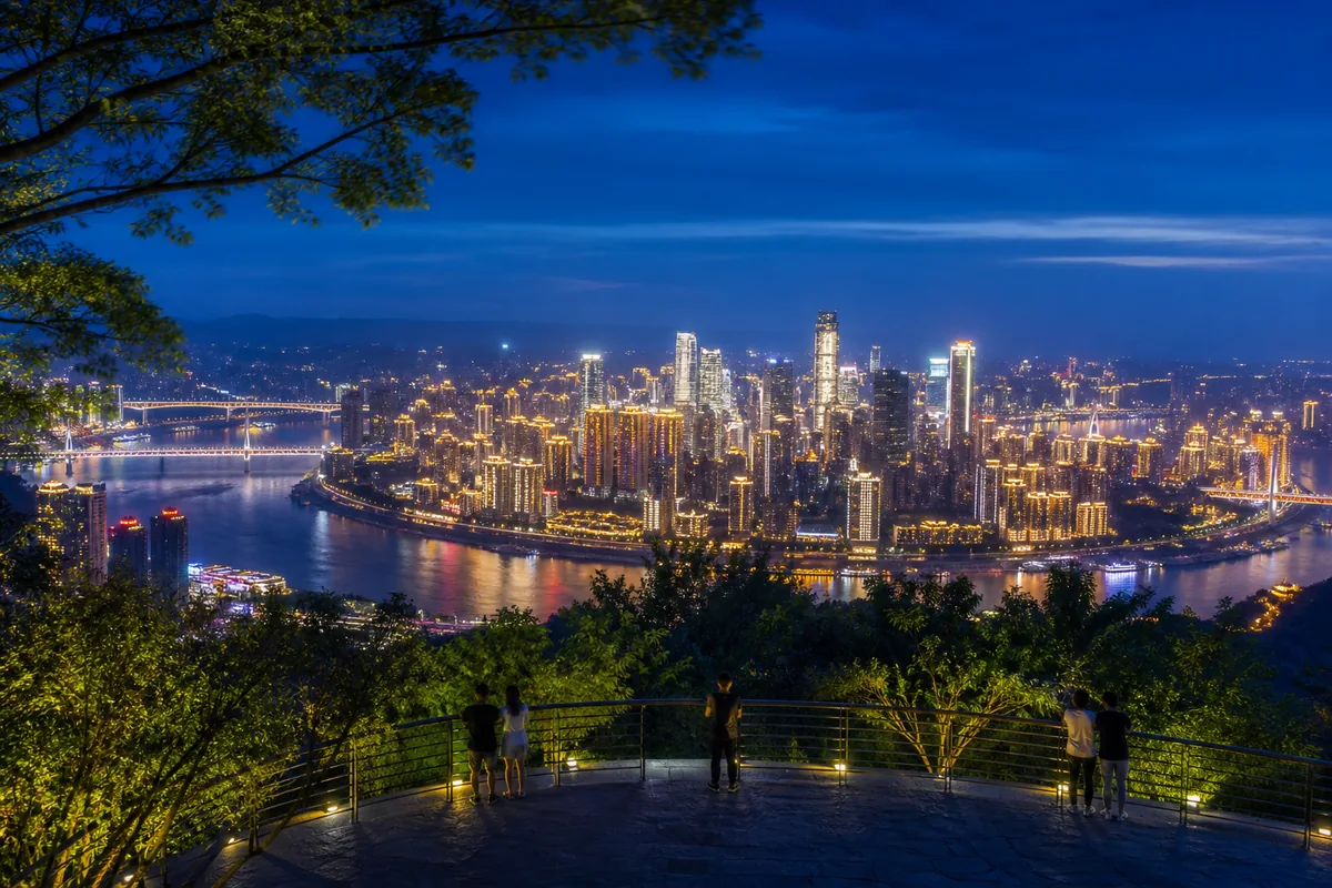 Illustrative night panorama of the illuminated Yuzhong peninsula from Nanshan